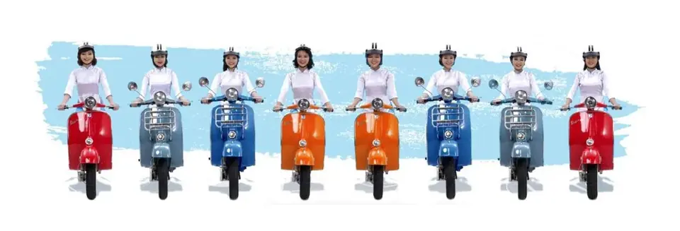 A line of XO Tours guides in white ao dai on pastel-coloured Vespa scooters