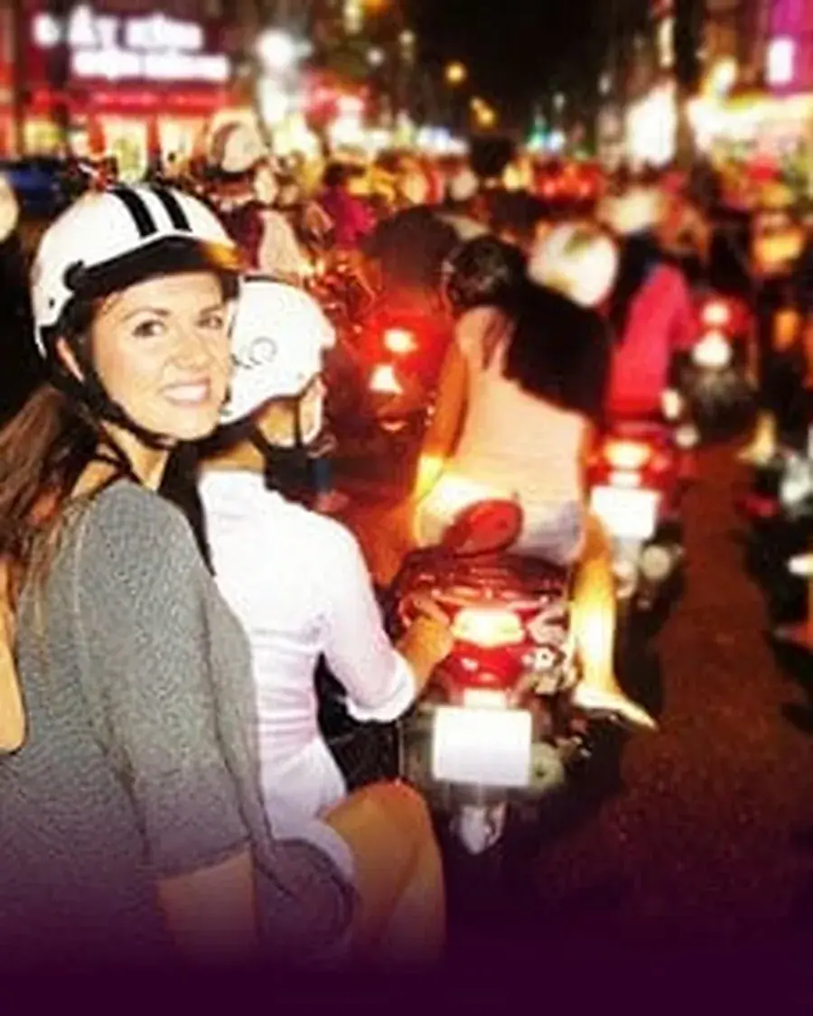 Guests and guides at a lively Saigon night market food stall
