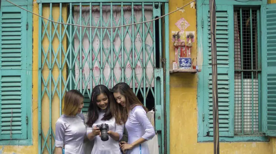 Looking at a camera on the Saigon Photography Tour